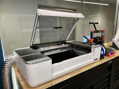 An image of a Glowforge, a 3D laser printer 