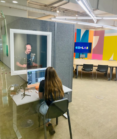 an image of two creators using the CO+LAB sound booth to record a podcast