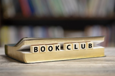 Image of book with Scrabble letters spelling out "Book Club"